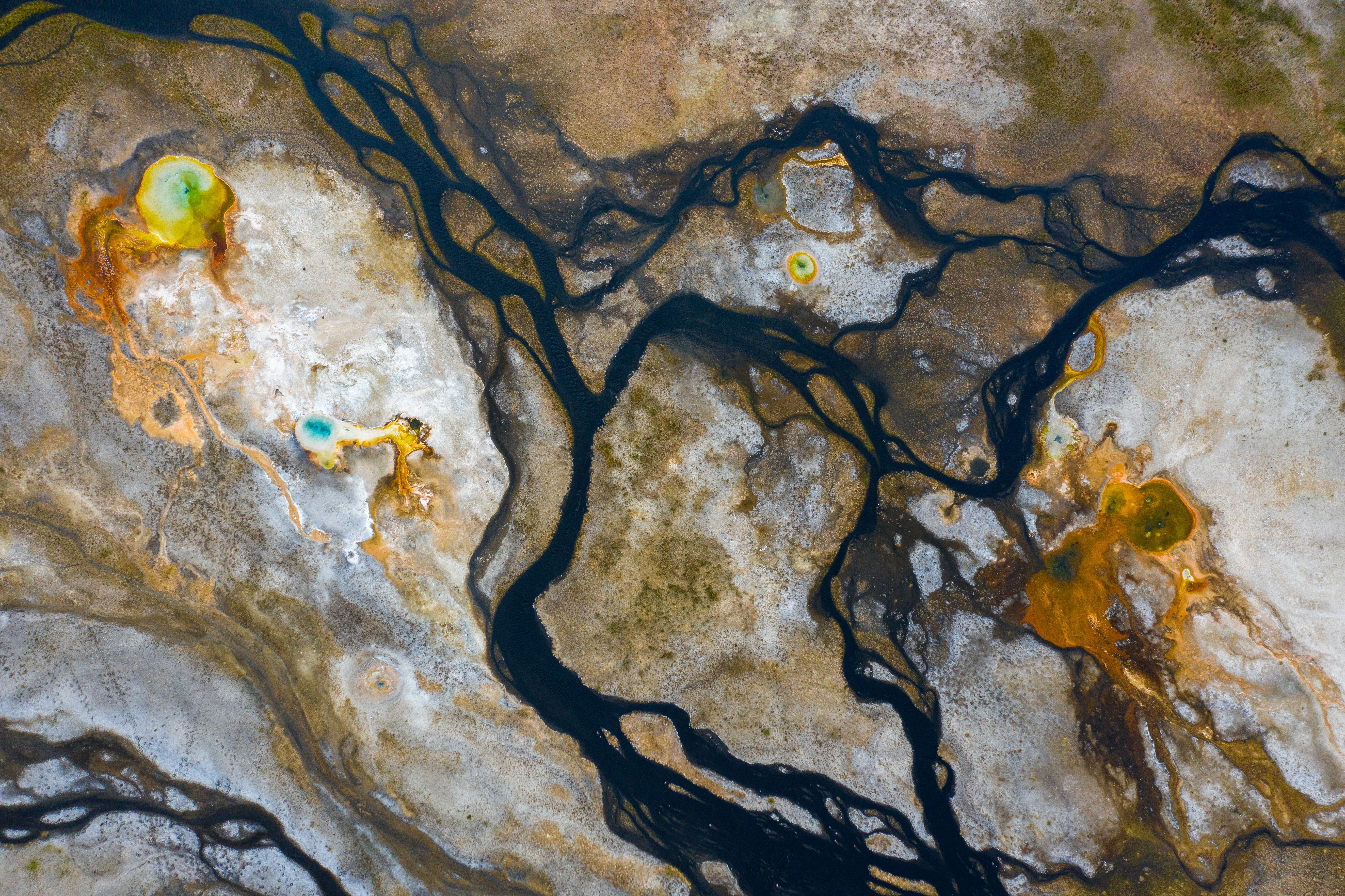 Squiggly rock formations, black brown, white and yellow. 